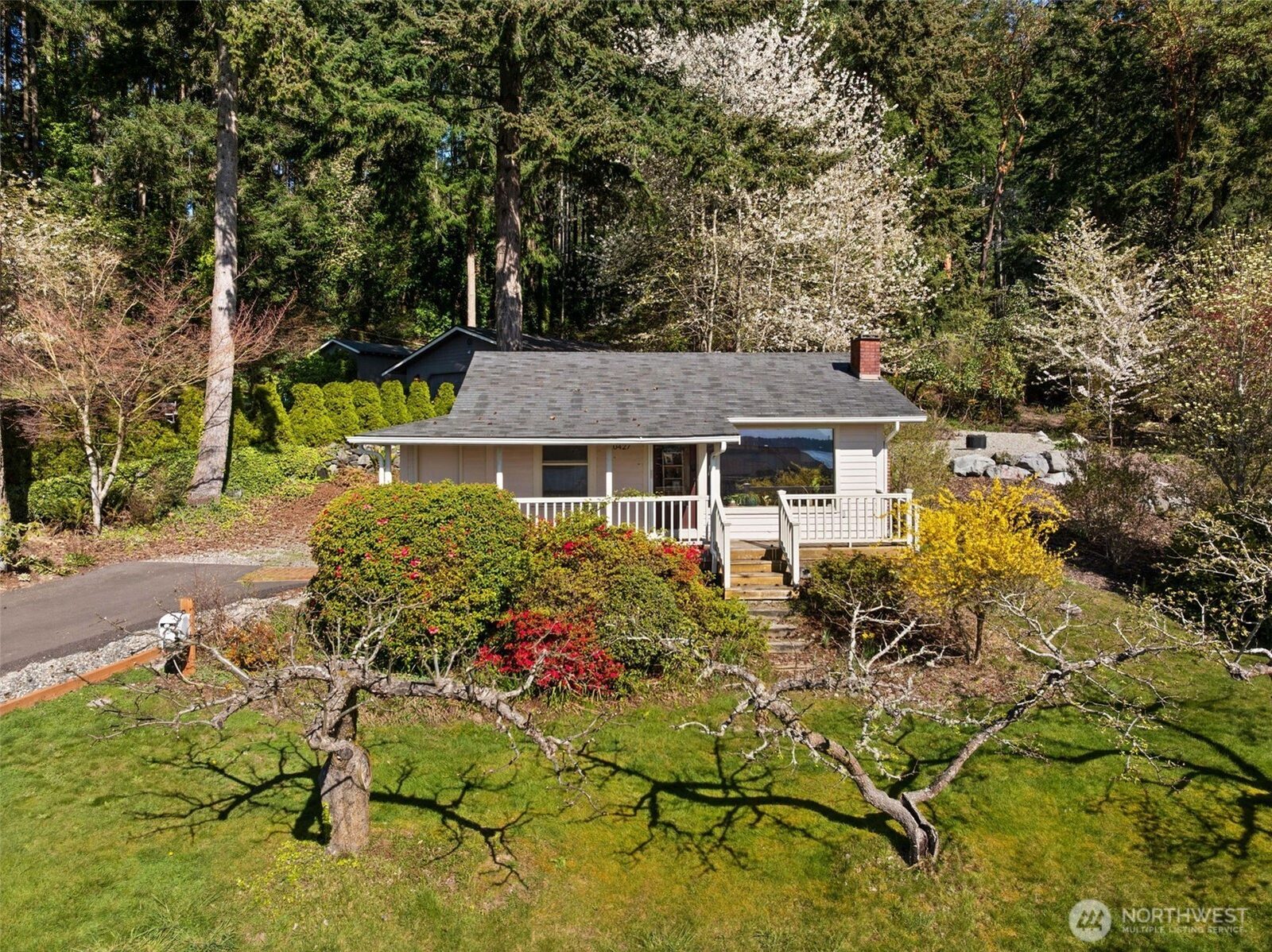Front of 10427 Powell Dr NW with its covered porch, lawn and trees